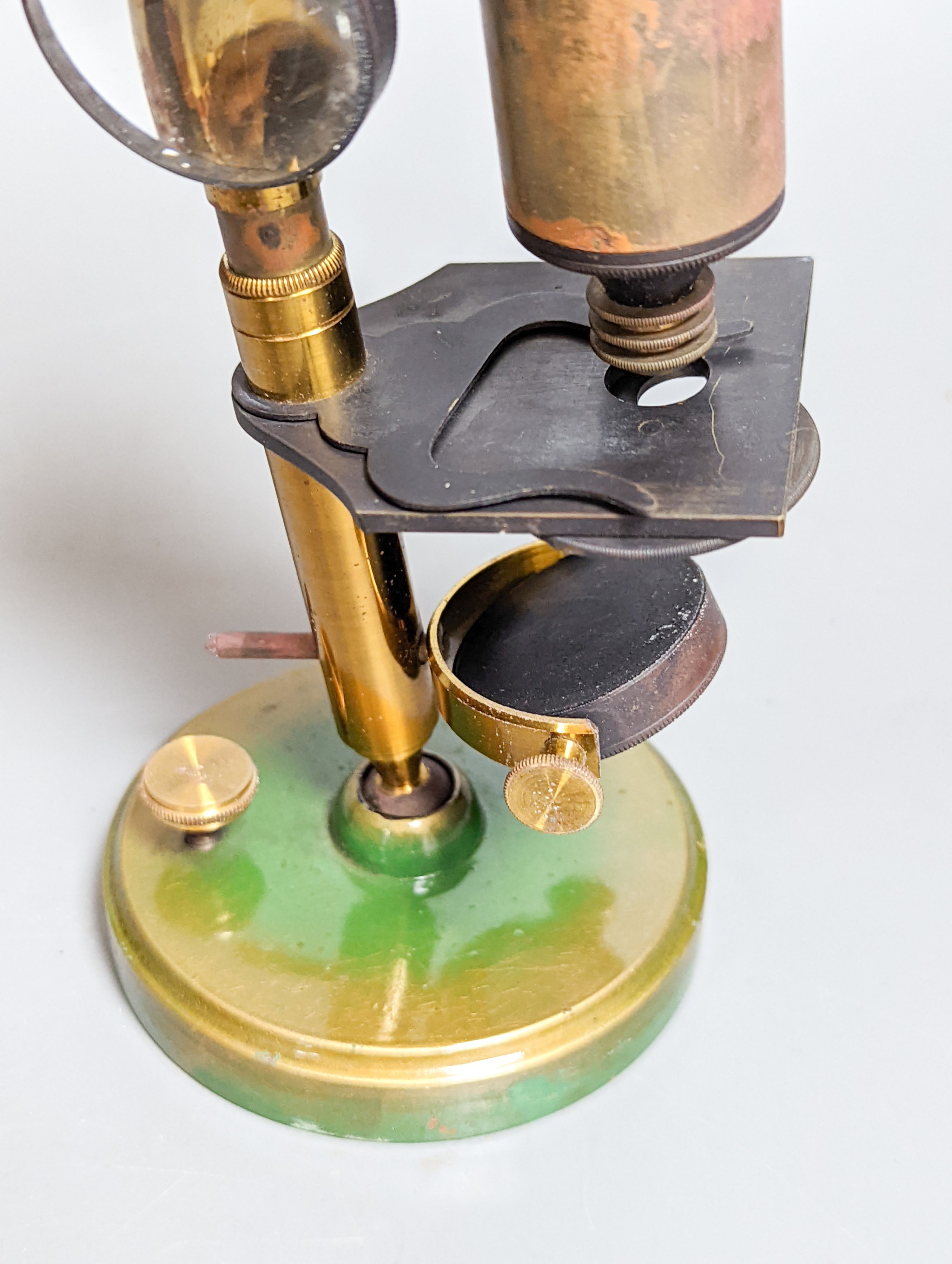 A mahogany cased brass compound microscope